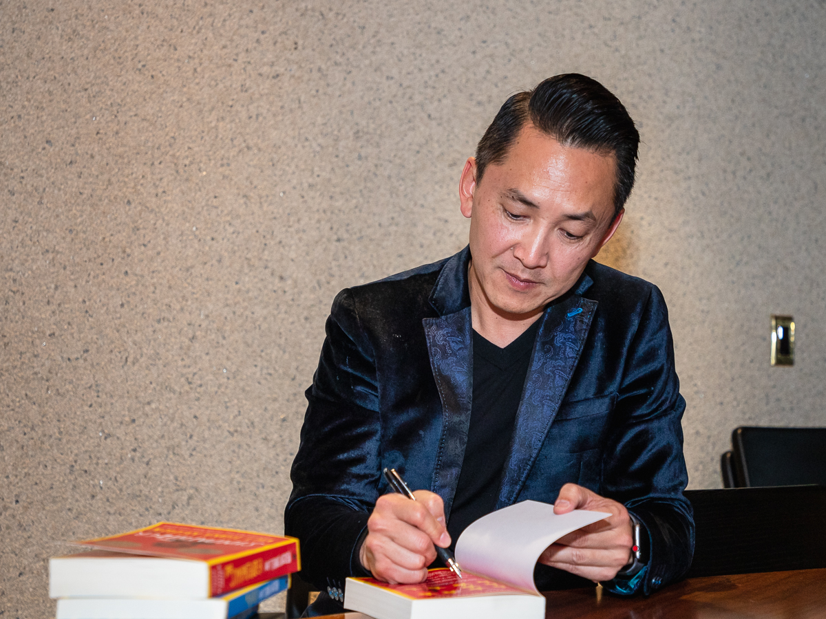 Viet Thanh Nguyen signing a copy of The Sympathizer